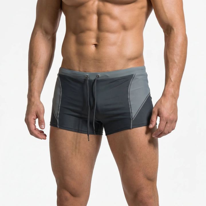Men's vibrant color block swim trunks. Fitted boxer style, great for active beach days.