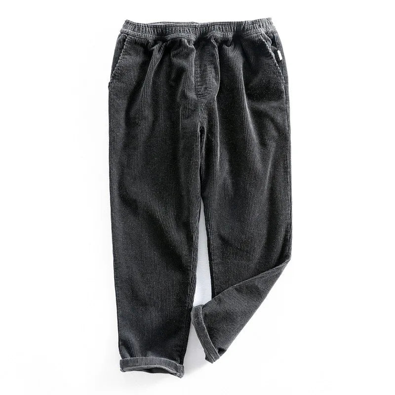Relaxed fit men's corduroy pants, offering comfort & stretch for daily wear. Classic solid color, suitable for casual style.