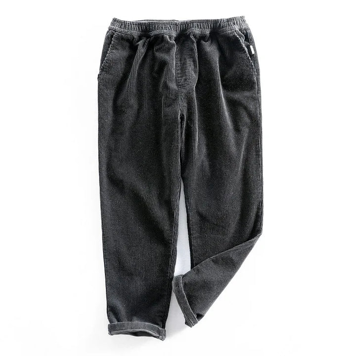 Relaxed fit men's corduroy pants, offering comfort & stretch for daily wear. Classic solid color, suitable for casual style.