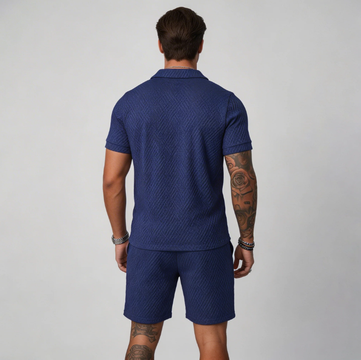 Men's warm weather set featuring a zip collar polo shirt and matching textured shorts. Great for a casual look.