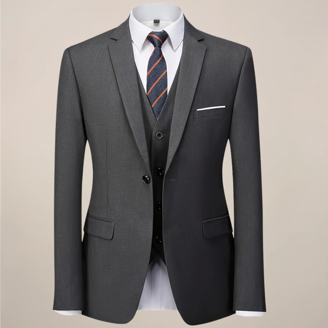 Elegant dark grey slim fit three-piece suit for men. Includes tailored jacket, vest & trousers, ideal for formal attire.