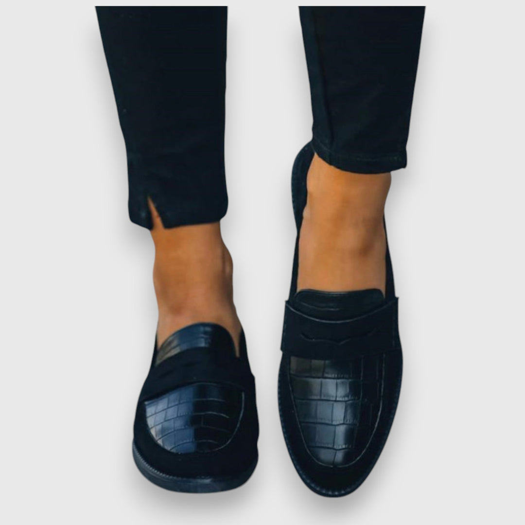 Classic men's black slip-on loafers. Elegant ergonomic design for versatile business casual to formal wear.