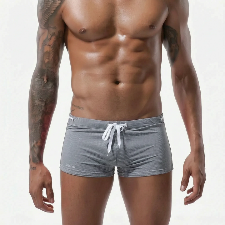 Low-rise men's fitted swim trunks, quick-dry material, ideal for beach, pool & active wear.