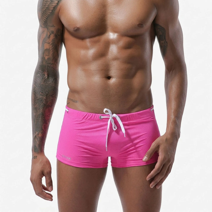 Textured men's swim trunks, short cut, low-rise fit, ideal for active pool or beach wear.