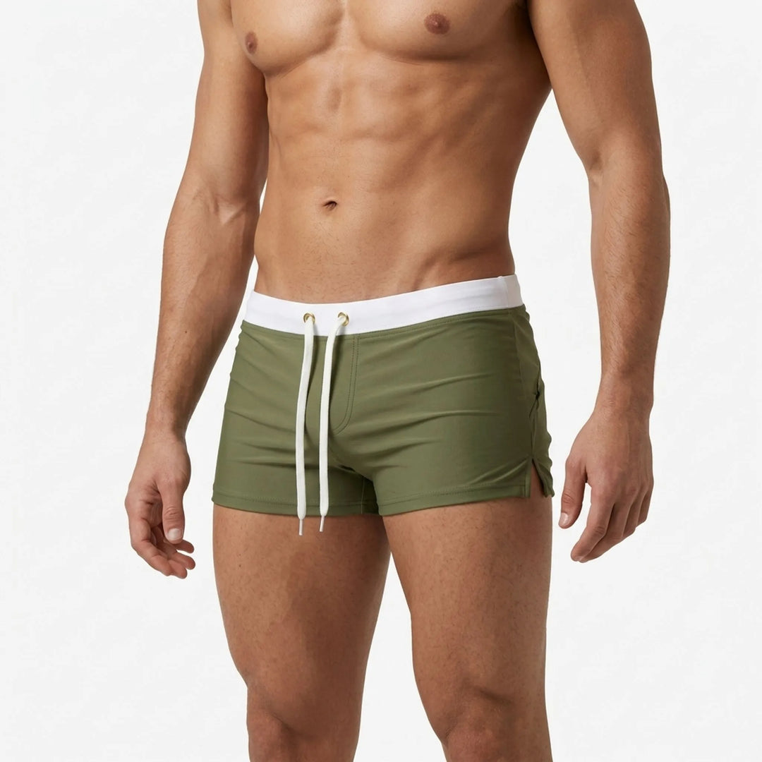 Comfortable men's quick-dry swim trunks, ideal for summer beachwear & athletic swims.