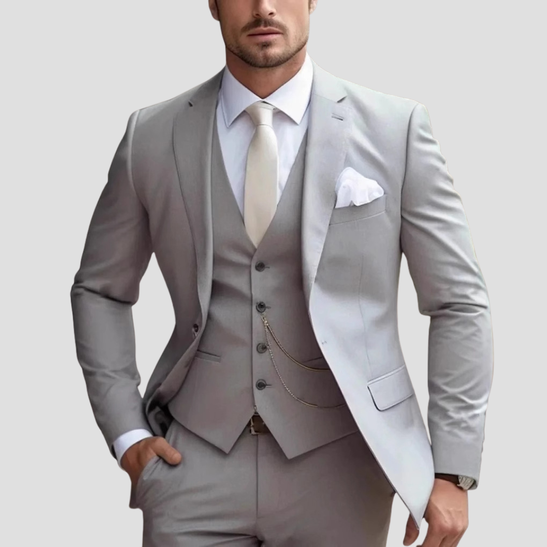 Man modeling a sharp slim fit three-piece suit, ideal formal wear for a wedding, business event, or gala.