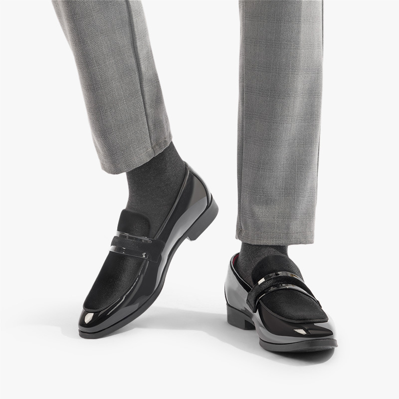 Close-up of men's sleek dress loafers with a high-shine glossy finish, perfect for formal events.