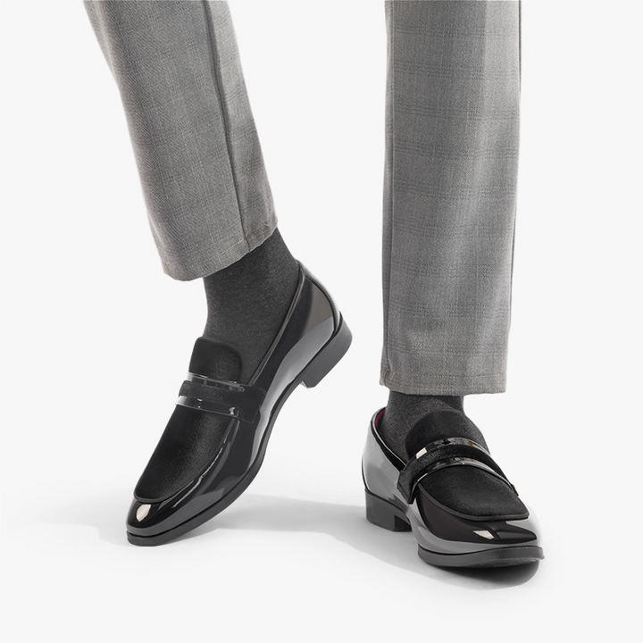 Close-up of men's sleek dress loafers with a high-shine glossy finish, perfect for formal events.