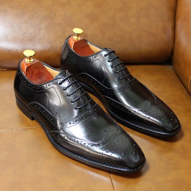 Classic men's wingtip Oxford brogues in premium handcrafted leather, ideal for formal business footwear.