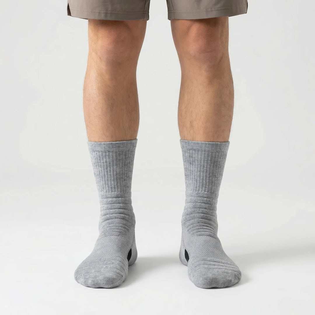 Three pairs of men's high-tube performance compression socks designed for ultimate comfort & support.