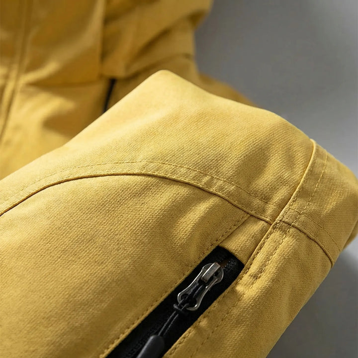 Comfortable men's softshell windbreaker jacket with hood, lightweight outdoor gear for hiking and travel.