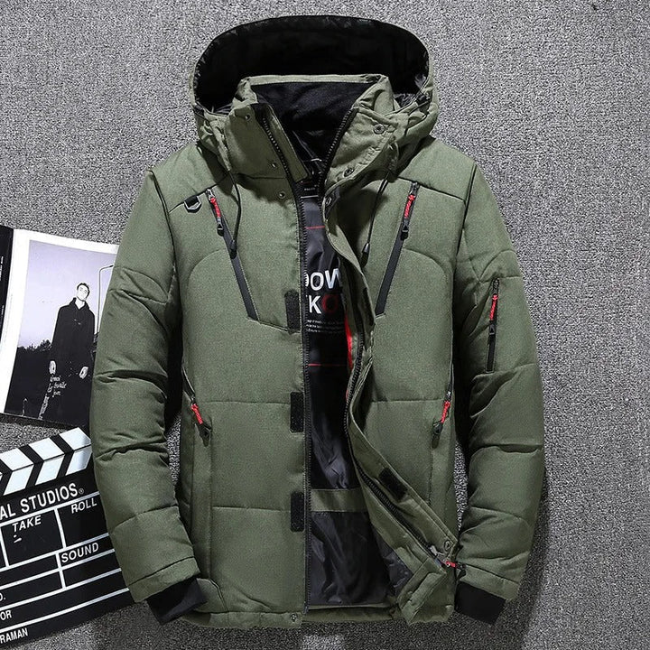 Man wearing a stylish insulated hooded parka outdoors. This all-weather men's jacket offers warmth & comfort.