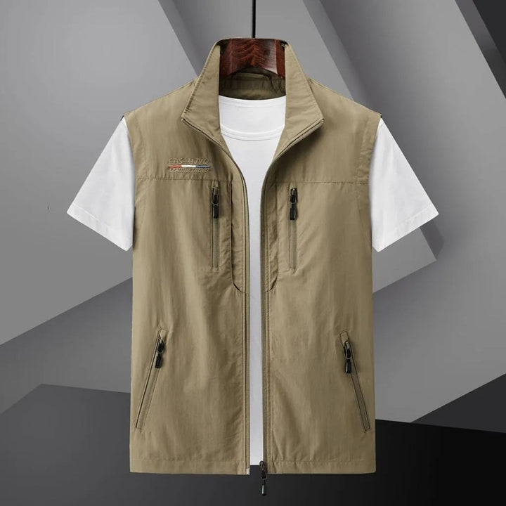 Stylish men's all-weather adventure vest with practical zip pockets, designed for active outdoor enthusiasts.