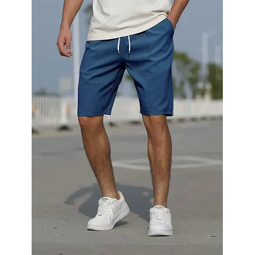 Man wearing lightweight high-waist shorts. Relaxed fit, casual comfort for summer travel. Everyday style.