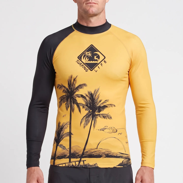 Man relaxing on the beach, wearing a comfortable long-sleeve UPF 50+ rash guard for stylish sun safety.