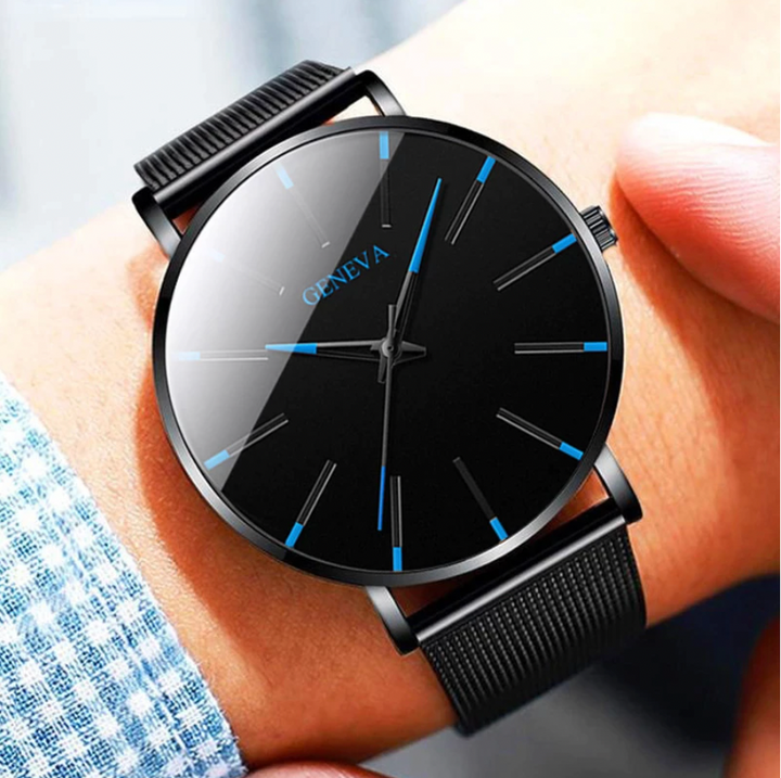 Close-up of a men's minimalist analog watch, featuring elegant blue hands & markers on a clean white dial.