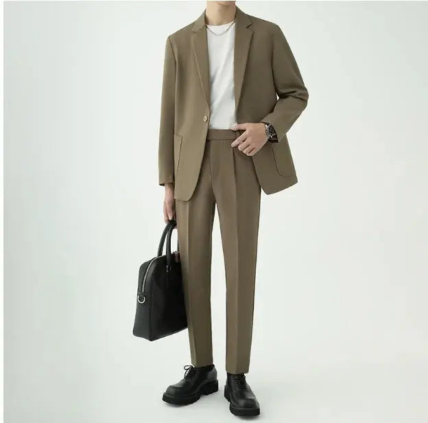 Man wearing a tailored modern minimalist men's suit, exuding sophistication for formal or business events.