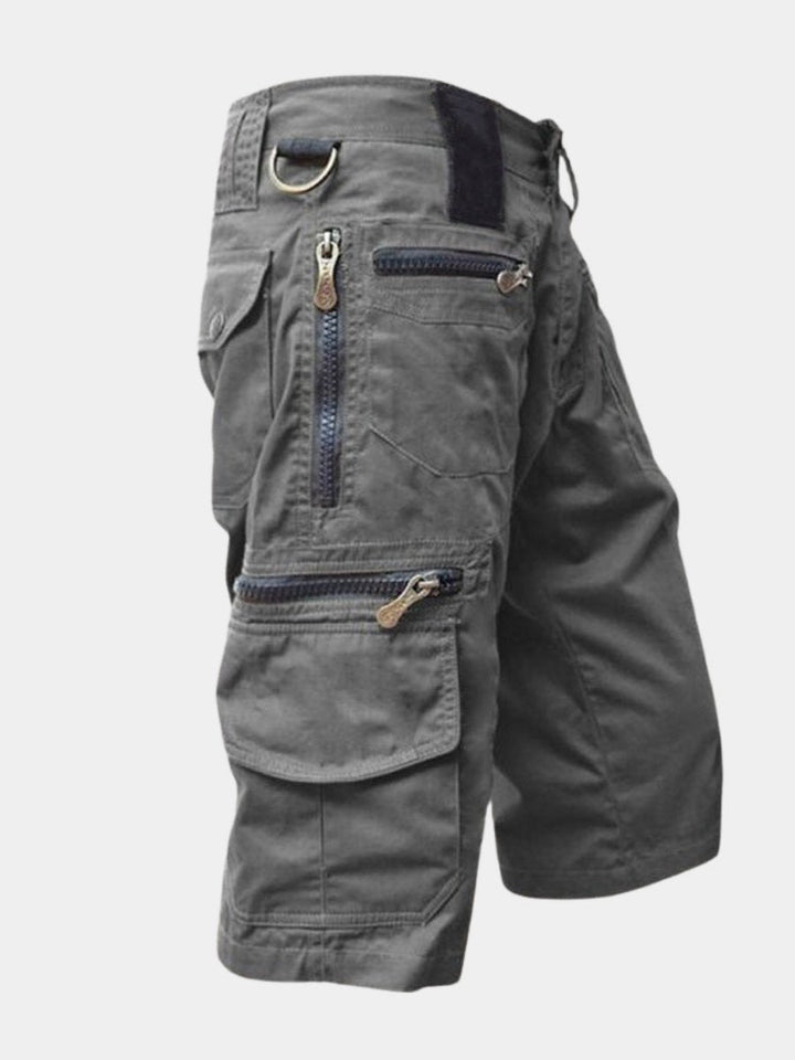 Men's multi-pocket cargo shorts in khaki, ideal for outdoor adventures & travel. Comfortable utility design.