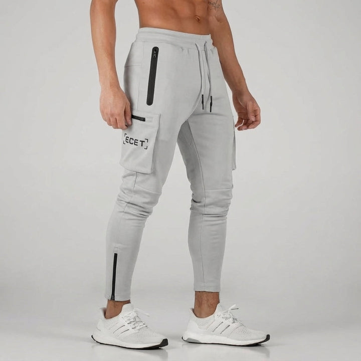 Performance men's sport pants: Grey joggers with secure pockets & drawstring waist for active men, gym to street.