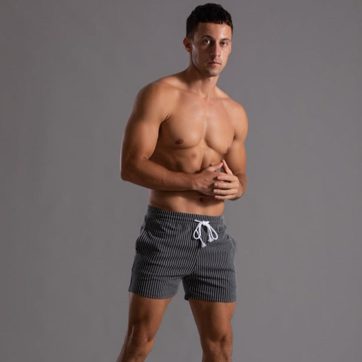Quick-dry ripstop polyester swim trunks for men. Stylish beachwear & pool shorts, summer-ready.