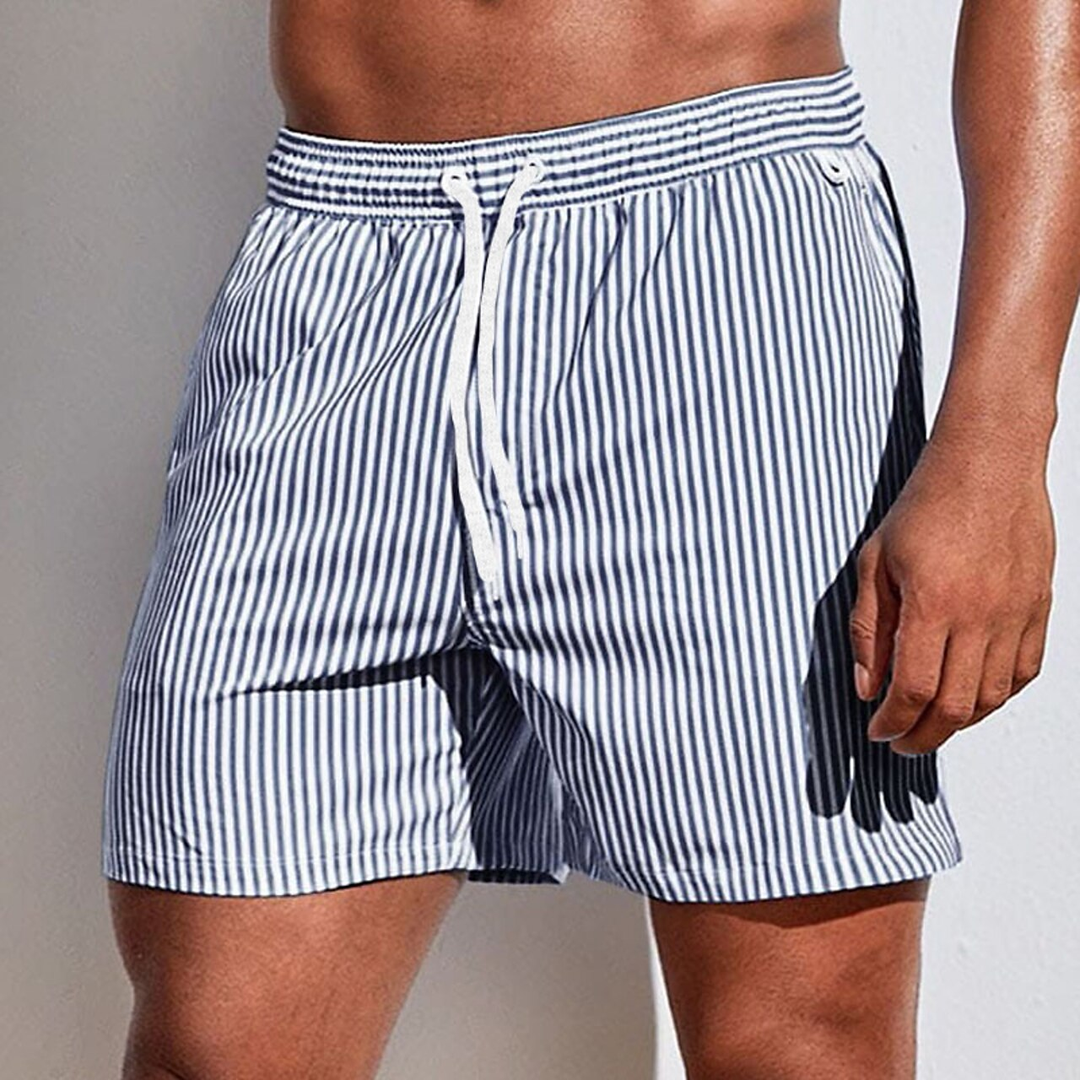 Vibrant striped men's swim shorts with drawstring, offering quick-dry comfort for active summer days & beach fun.