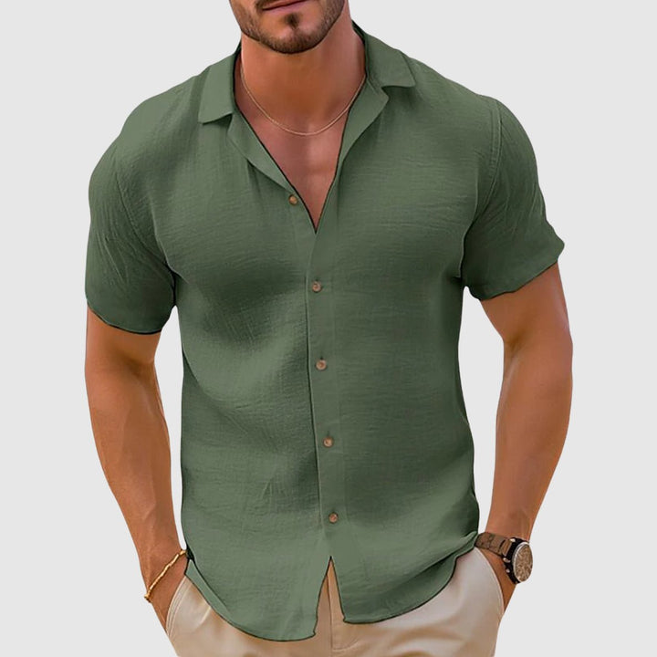 Man in a relaxed fit short sleeve button-up shirt, enjoying a comfortable and stylish summer day.