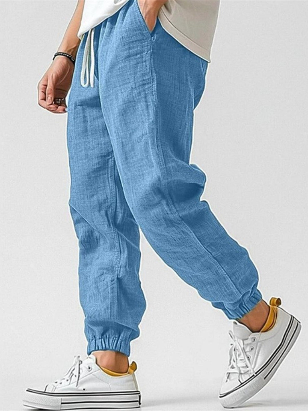 Men's tapered fit jogger pants with cuffed hems and drawstring, ideal for active casual wear & comfort.
