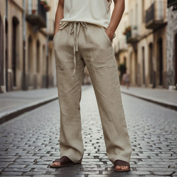 Man in relaxed fit drawstring linen trousers, ideal for beach or casual summer outings & travel.