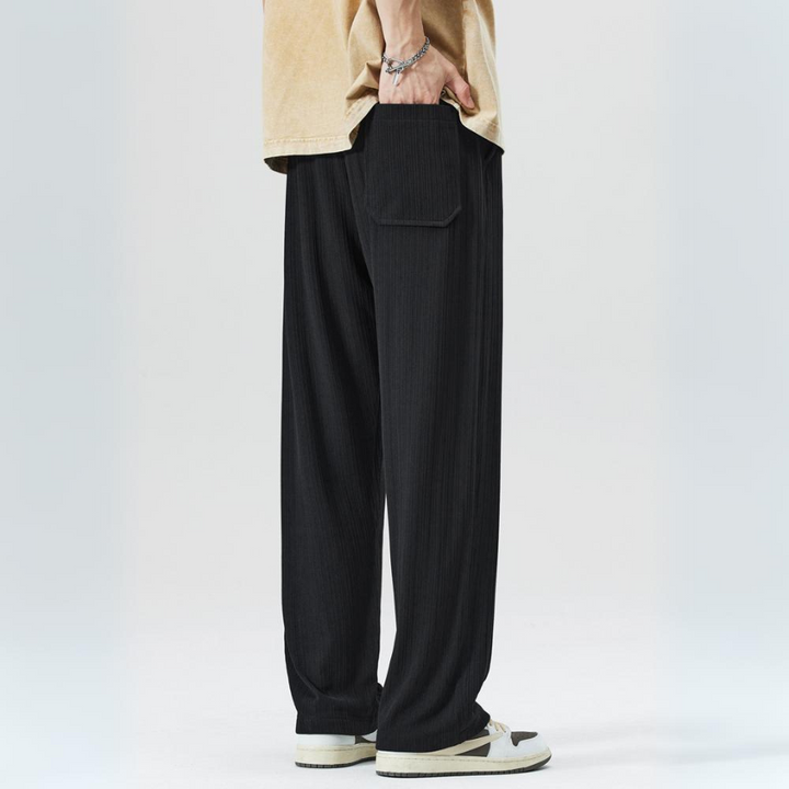 Front view of men's relaxed fit pleated trousers. Smart casual bottoms with comfortable elastic waist.