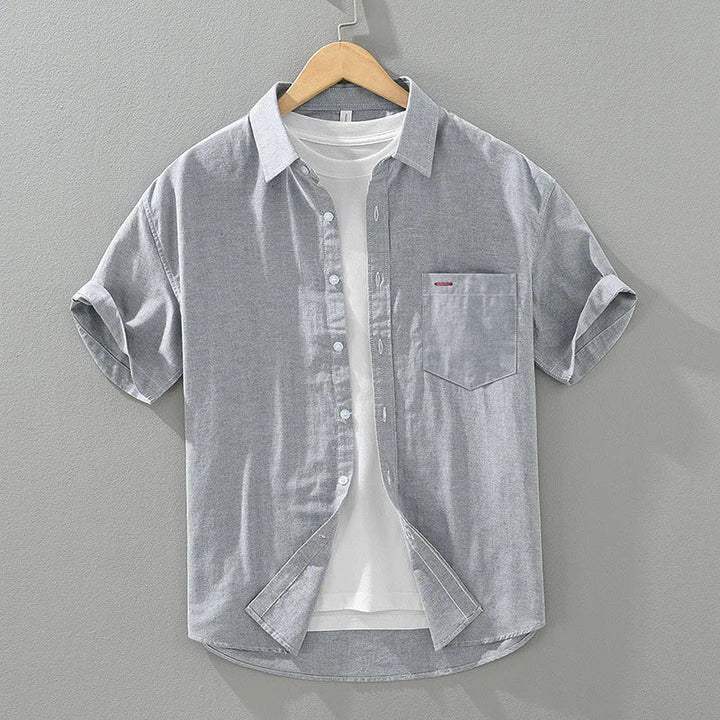 Stylish men's relaxed fit summer shirt. Short sleeve, solid color button-up for versatile casual looks.