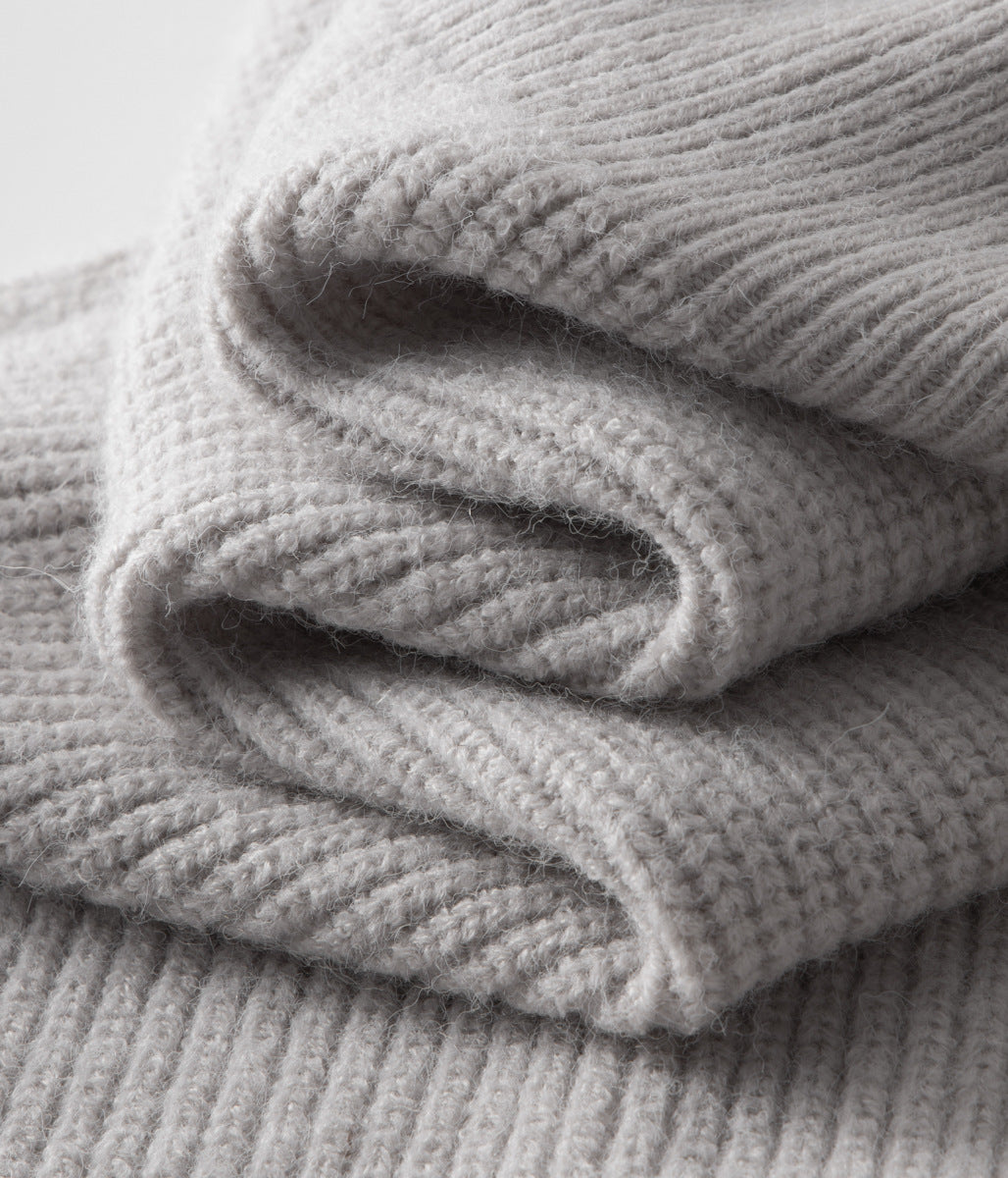 Close-up of the ribbed texture on a stylish men's funnel neck zip cardigan.