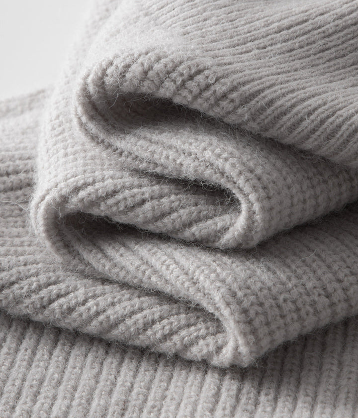 Close-up of the ribbed texture on a stylish men's funnel neck zip cardigan.