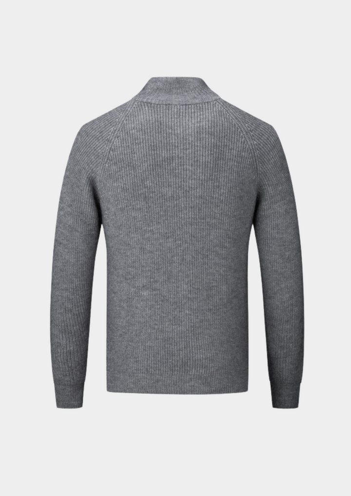 Close-up of ribbed knit texture on a men's zip-through sweater, funnel neck detail.