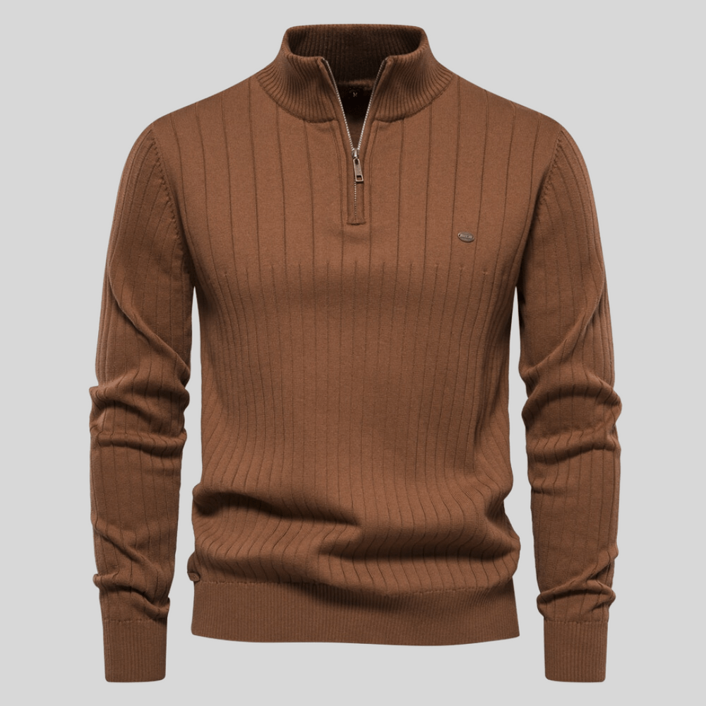 Detailed view of a men's ribbed mock neck half zip sweater. Highlights texture, zipper, and collar design.