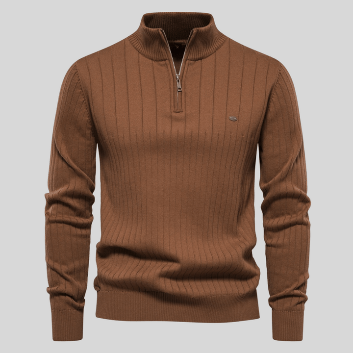 Detailed view of a men's ribbed mock neck half zip sweater. Highlights texture, zipper, and collar design.