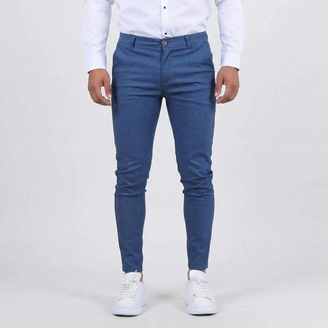 Man walking confidently in slim fit chino pants, demonstrating their flexible everyday style & comfort.