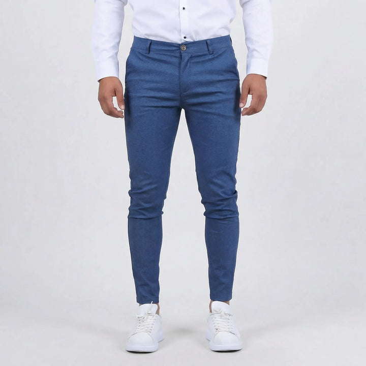 Man walking confidently in slim fit chino pants, demonstrating their flexible everyday style & comfort.