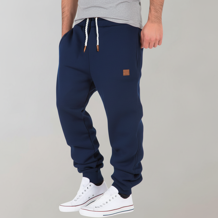 Versatile men's slim-fit joggers with convenient pockets. Essential casual pants for active and relaxed days.