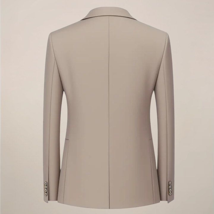 Man wearing a sharp khaki slim fit three-piece suit, styled for a wedding or sophisticated formal event.