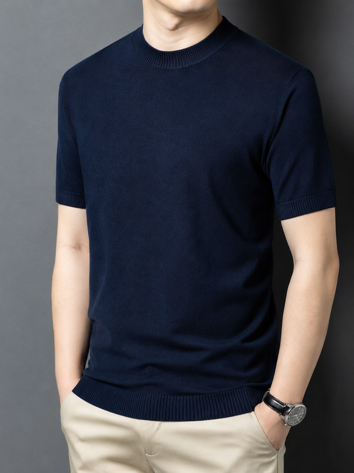 Model in a grey slim fit mock neck t-shirt, short sleeve, showcasing casual style.