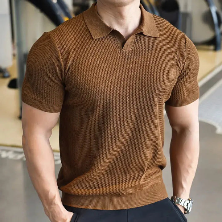 Stylish men's textured slim fit polo shirt, short sleeve, laid flat. Ideal versatile top for comfortable casual daily wear.