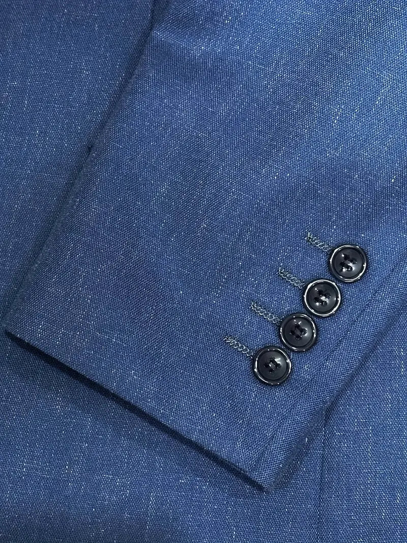 Man modeling a stylish slim fit two-piece suit, showing elegant blazer & trousers, perfect for events.