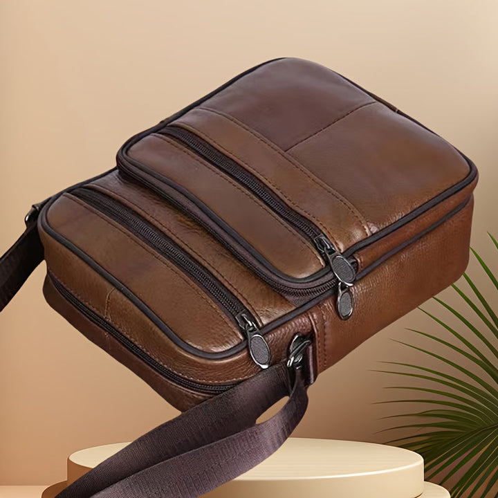 Organized men's travel shoulder bag, spacious compartments, adjustable strap for essentials.