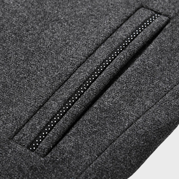 Close-up of the stand collar and side pockets on a men's business trench coat, showing detail.