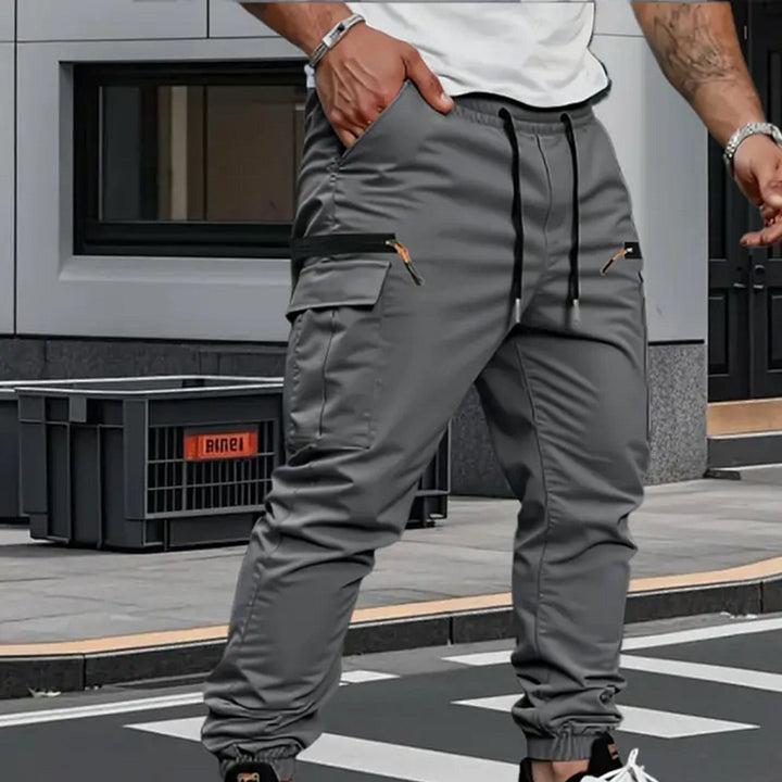 Versatile men's stretch cargo jogger pants for comfort, style, & activewear. Tapered fit and drawstring waist.