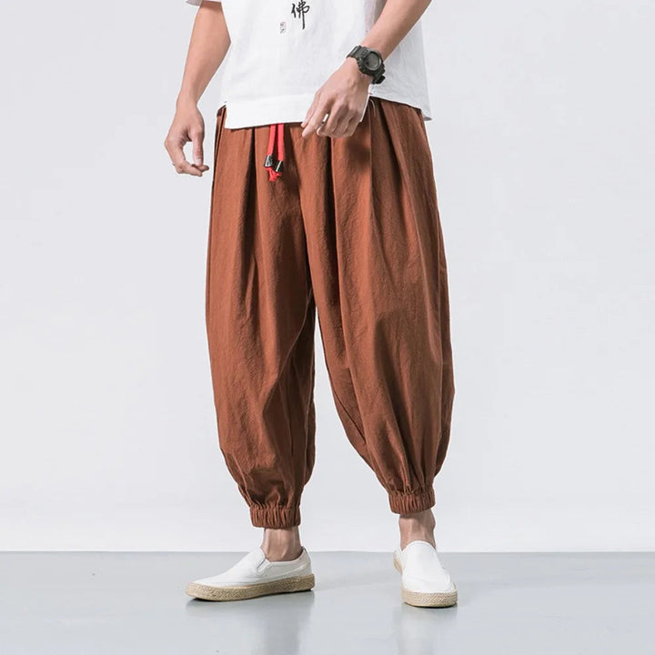 Close-up of men's Harem Jogger Pants elastic waist & drawstring, emphasizing comfort and adjustability.