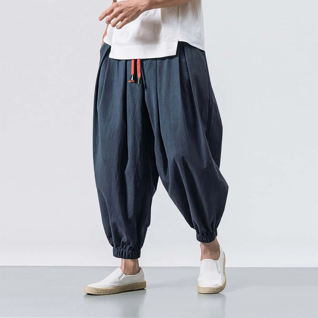 Side view of men's baggy harem jogger pants, highlighting comfortable, relaxed fit for active or casual wear.