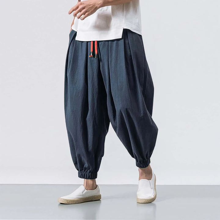 Side view of men's baggy harem jogger pants, highlighting comfortable, relaxed fit for active or casual wear.