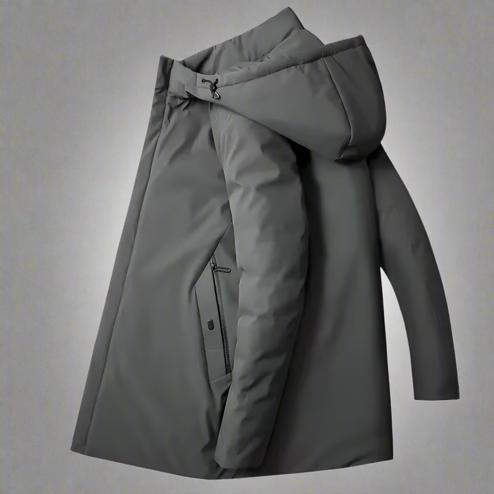 Full body shot of a man in a gray insulated hooded winter coat, perfect for cold weather fashion.