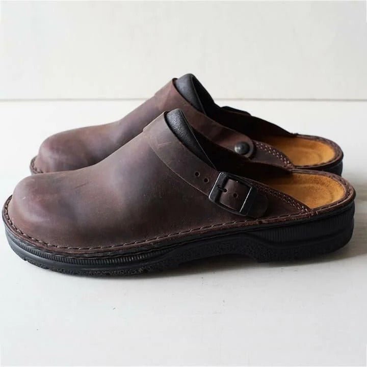Stylish men's mules featuring a supportive heel strap. Comfortable slip-on design for versatile indoor/outdoor use.